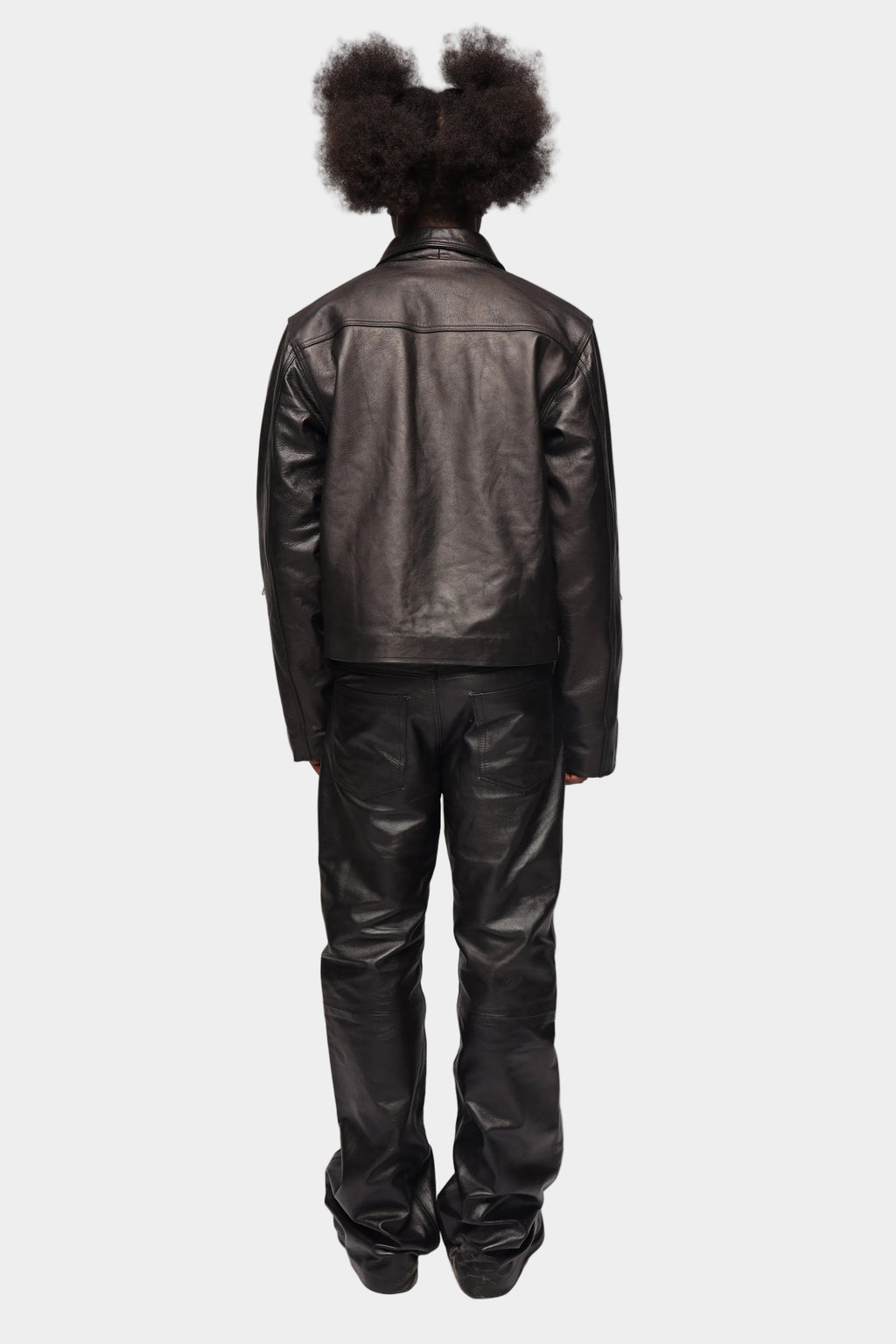 Kaleb A. Bearden zipped leather cargo pants showing multiple pockets and zipper details on a neutral background