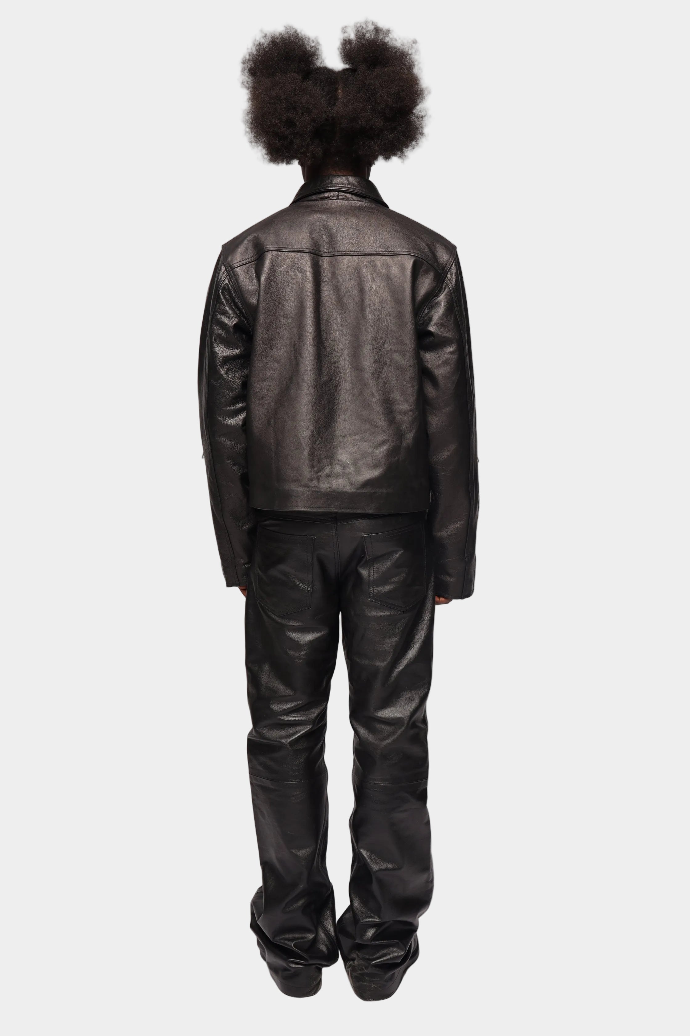 Kaleb A. Bearden zipped leather cargo pants showing multiple pockets and zipper details on a neutral background