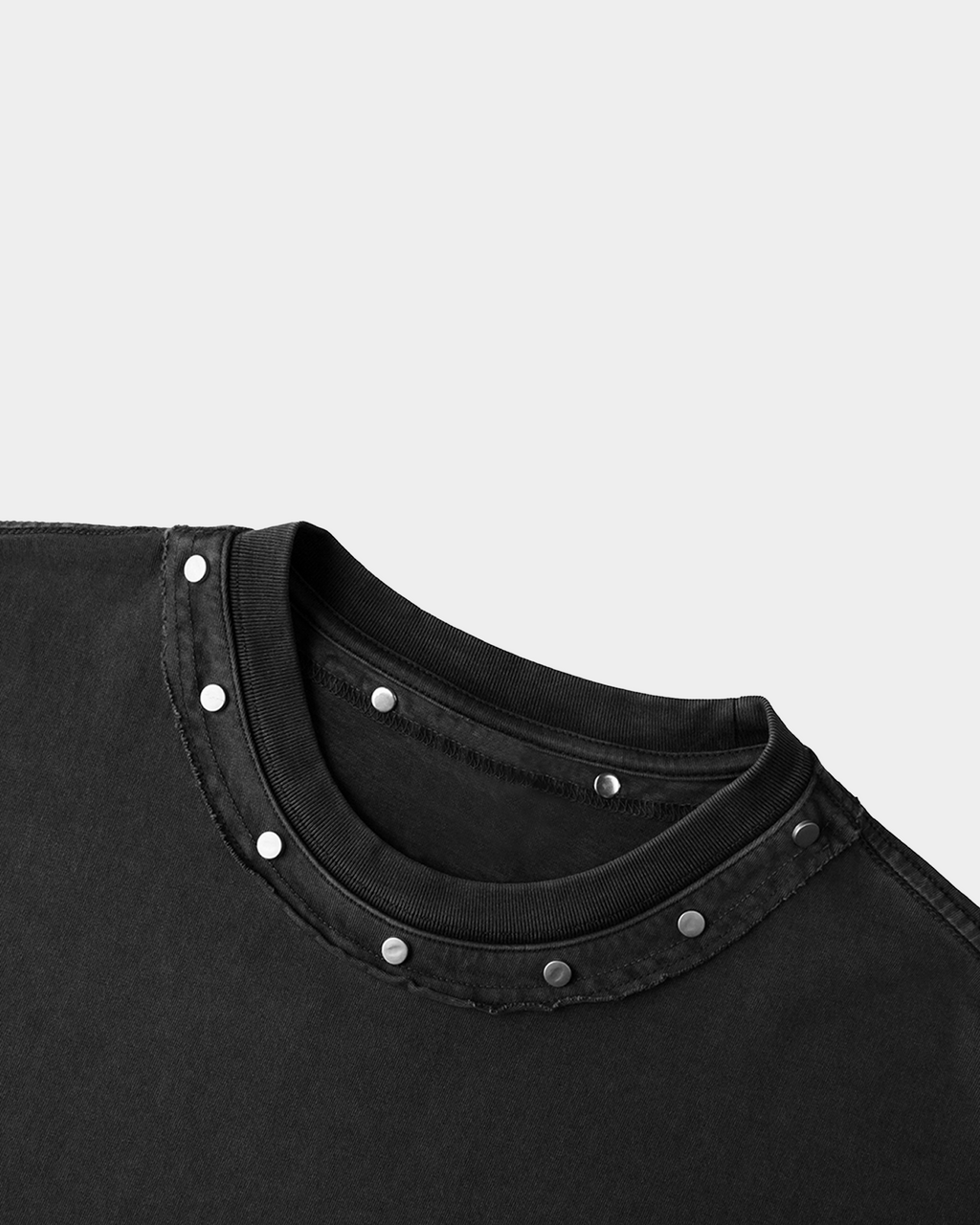 Black studded T-shirt by Kaleb A. Bearden featuring metal studs along the shoulders and chest area.