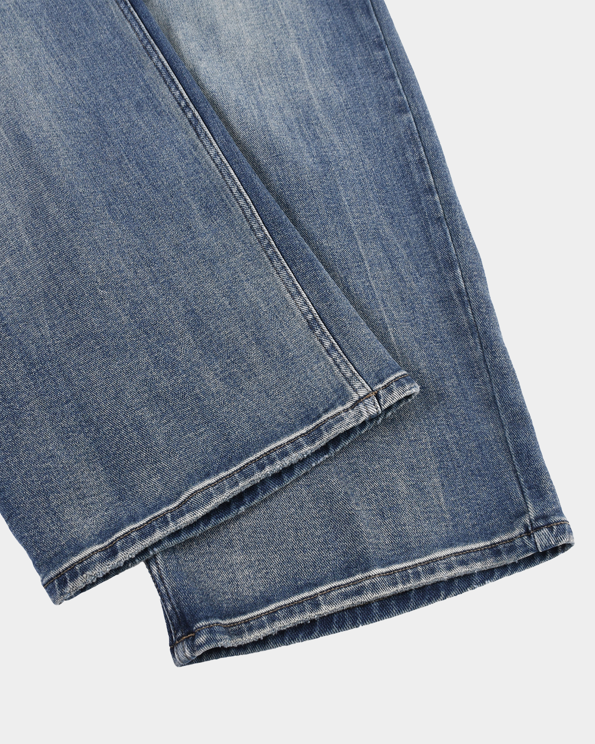 Vintage workwear jeans by Kaleb A. Bearden, rugged denim pants with a classic fit and distressed detailing.