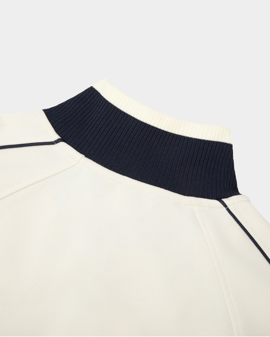 Kaleb A. Bearden Home Blues Track Jacket in navy with white stripes, sporty design, and zip-up front on a plain background.