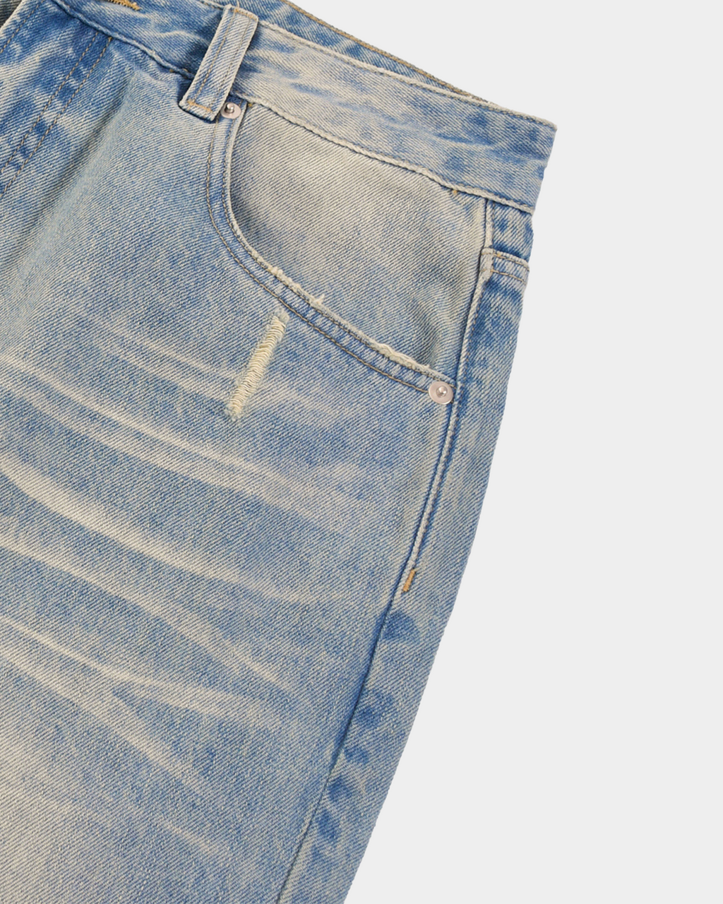 Sun-faded denim pants by Kaleb A. Bearden, showcasing a relaxed fit with light wash and distressed detailing.