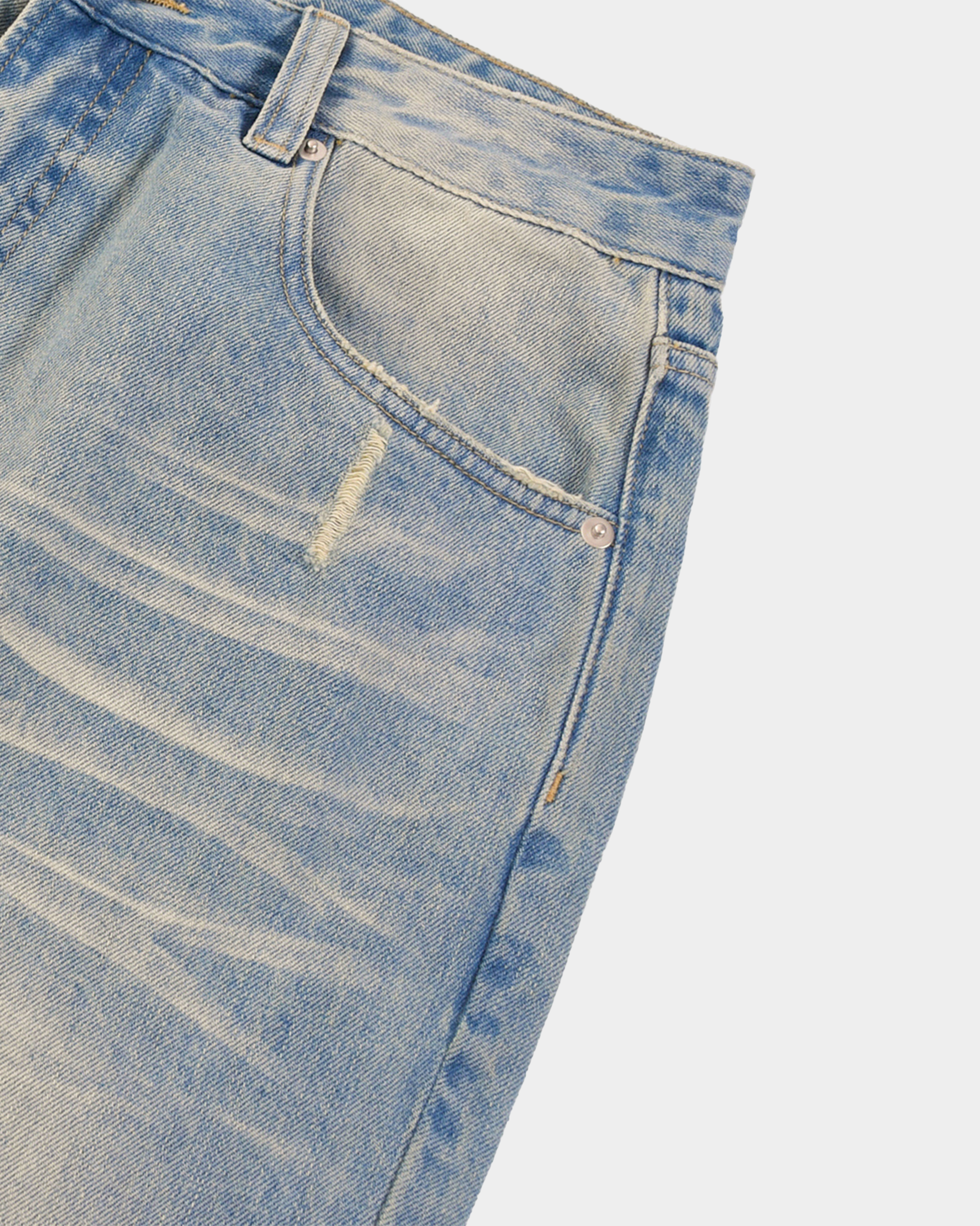 Sun-faded denim pants by Kaleb A. Bearden, showcasing a relaxed fit with light wash and distressed detailing.