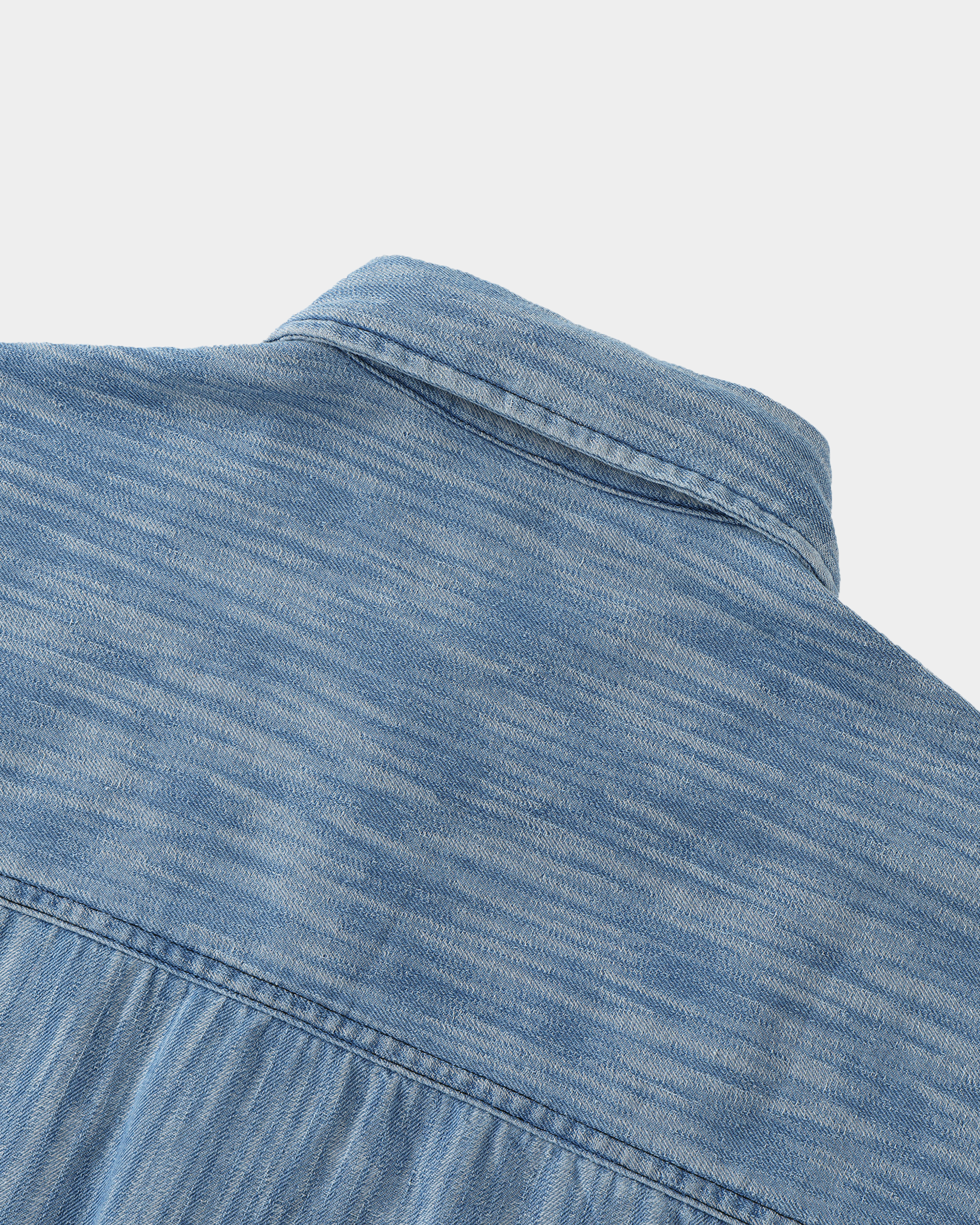 Washed denim panel shirt by Kaleb A. Bearden featuring a relaxed fit, button-up front, and contrasting denim panels.