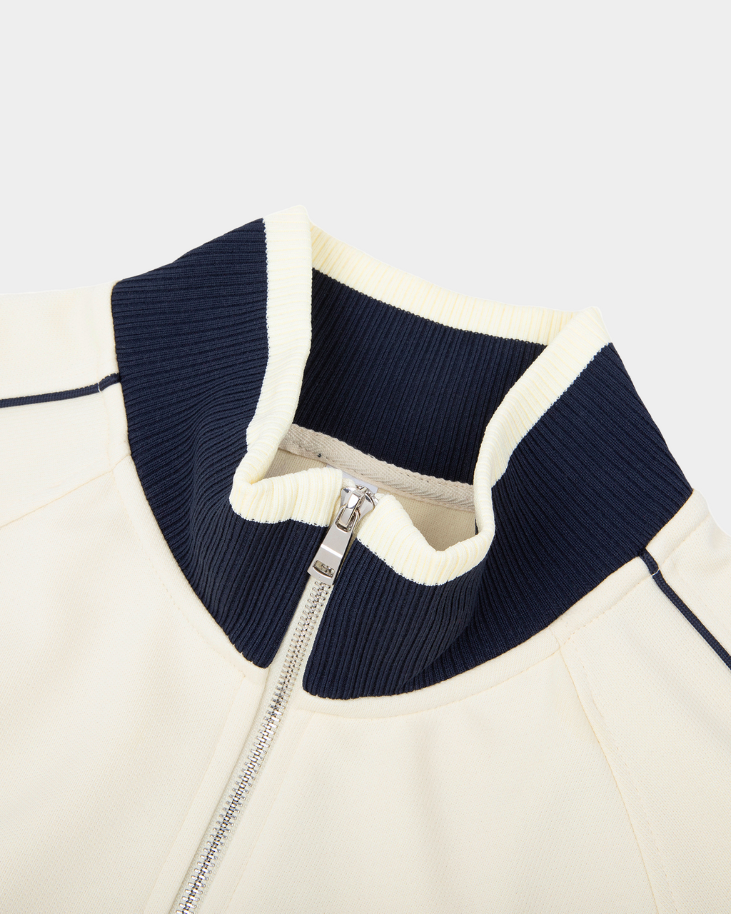 Kaleb A. Bearden home blues track jacket with blue fabric and athletic style, front view showing zip-up closure and collar.