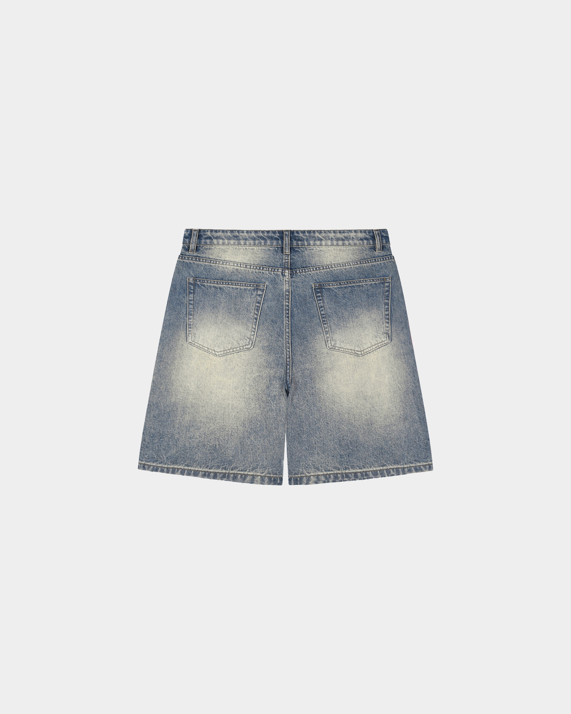 Faded baggy denim shorts by Kaleb A. Bearden with distressed details and relaxed fit, shown on a model.