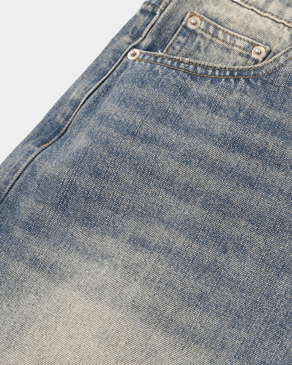 Faded baggy denim shorts by Kaleb A. Bearden featuring distressed details and loose fit, styled with rolled cuffs.