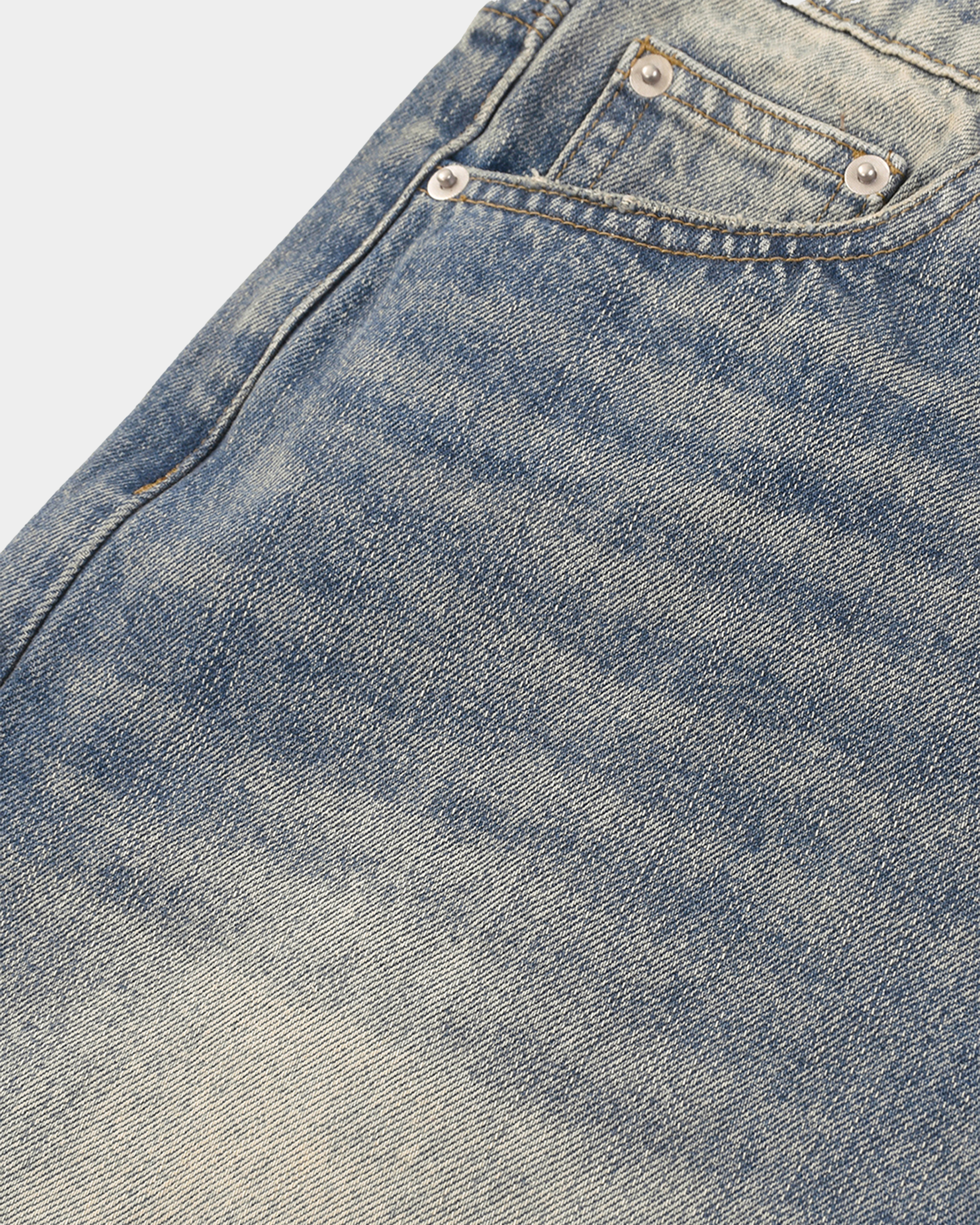 Faded baggy denim shorts by Kaleb A. Bearden featuring distressed details and loose fit, styled with rolled cuffs.