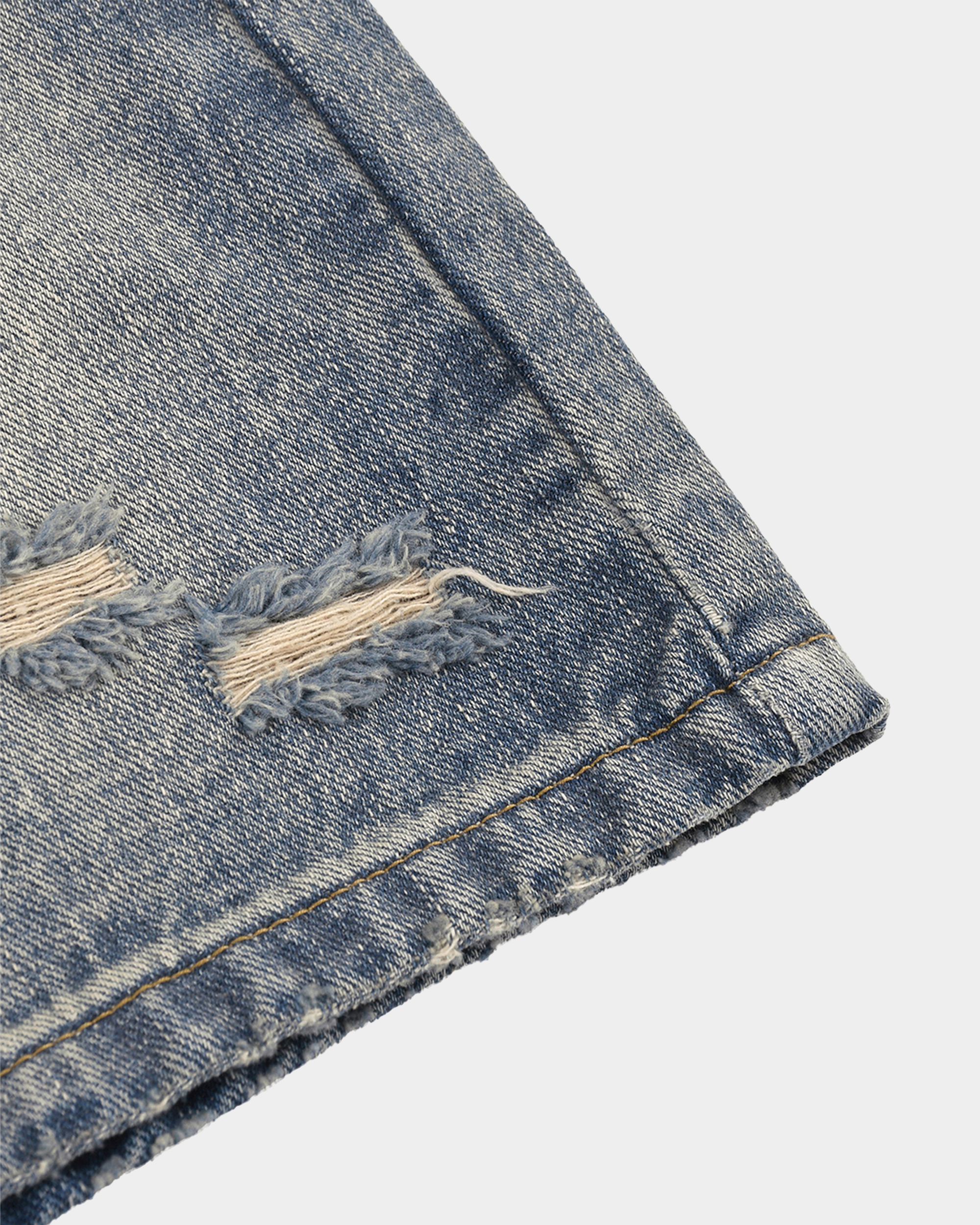 Faded baggy denim shorts by Kaleb A. Bearden with distressed details and relaxed fit, shown on a model.