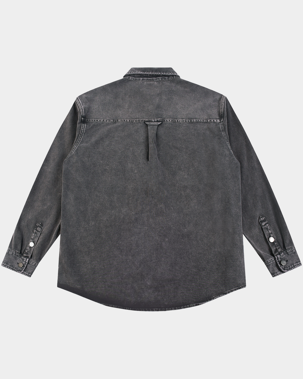 Kaleb A. Bearden Monogram Washed Denim Overshirt hanging on a wooden hanger, showcasing its casual style and washed denim fabric.