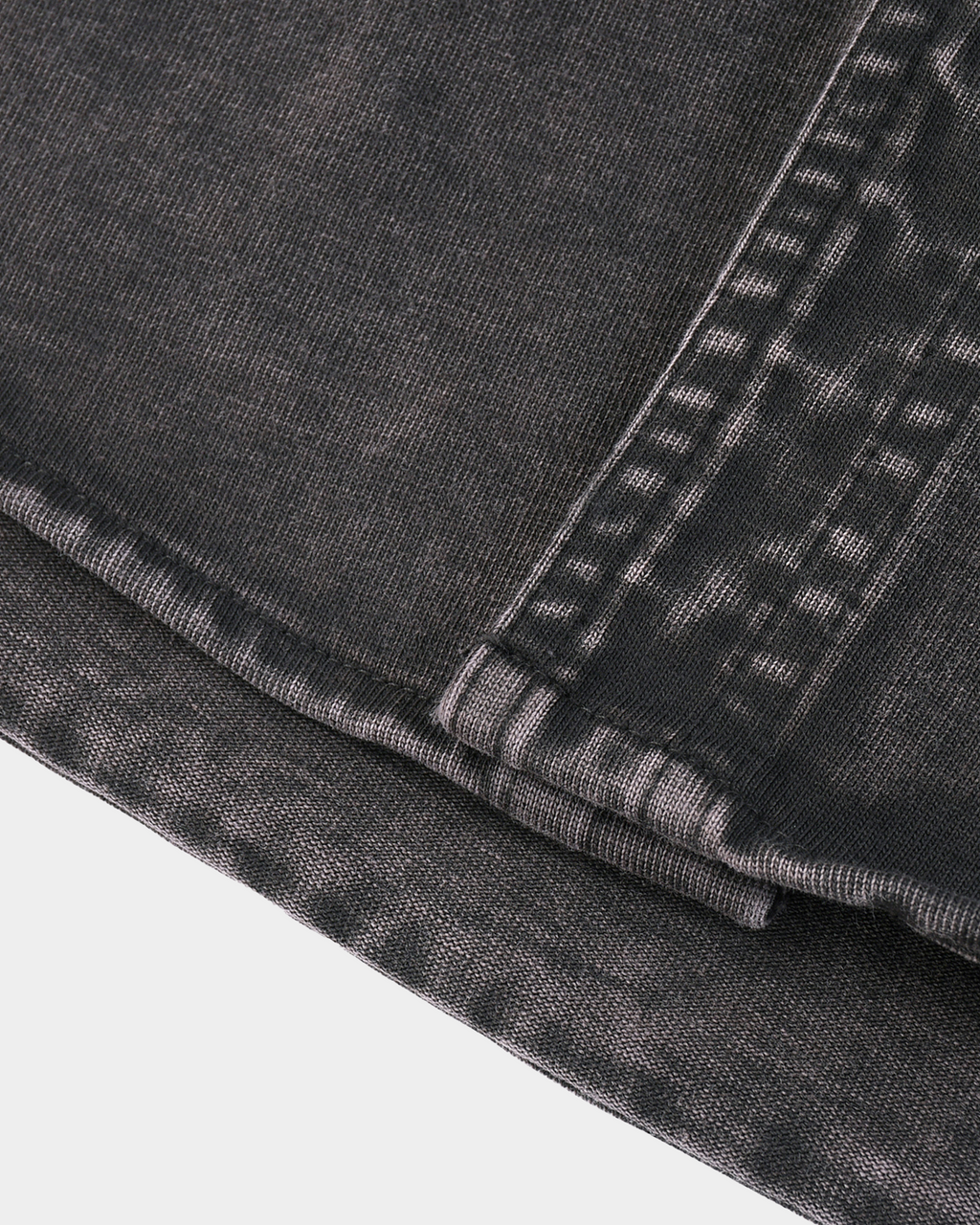 Kaleb A. Bearden Monogram Washed Denim Overshirt hanging on a rack with a classic washed denim look and subtle monogram details.