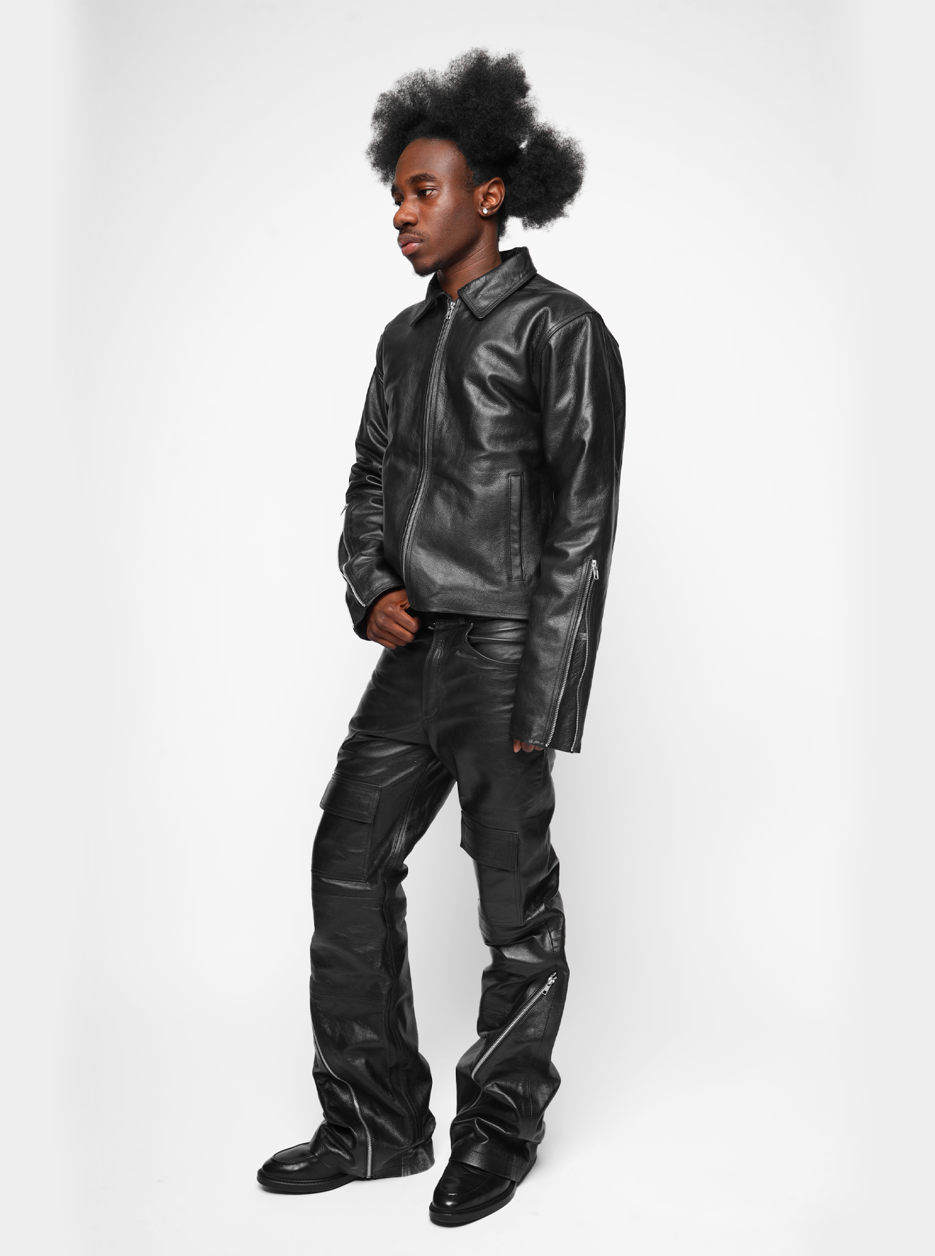 Kaleb A. Bearden zipped leather cargo pants showing front view with multiple pockets and zipper details.